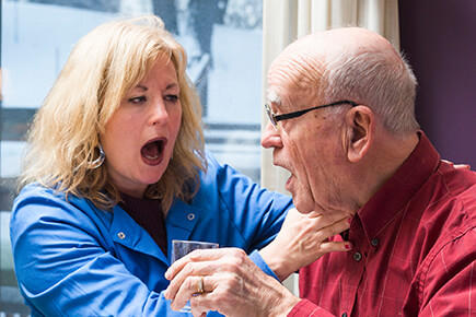 Speech therapist listens for dry voicing after swallowing