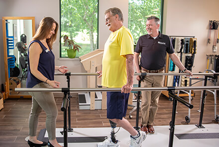 Physical therapy - man with prosthetic leg walking